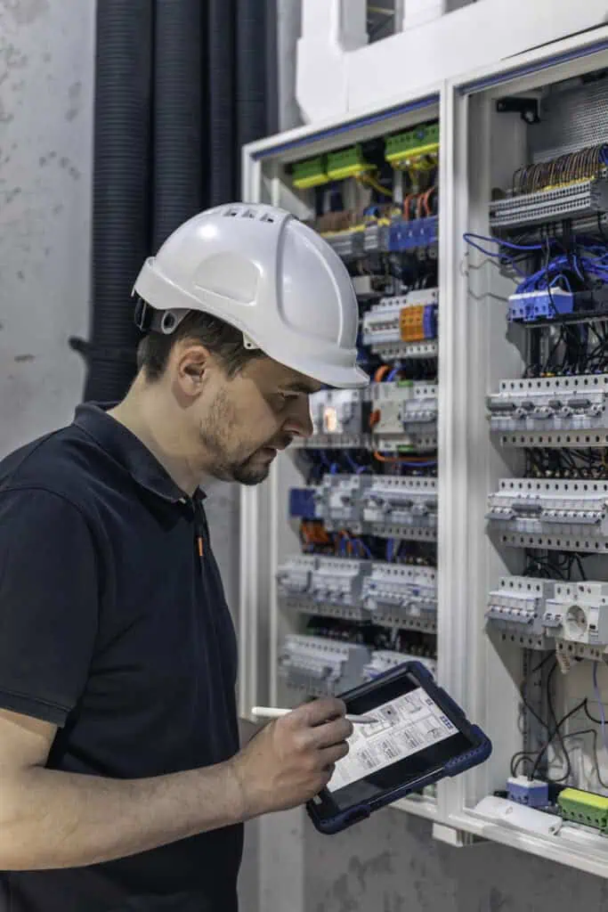 PLC automation engineer services checking the performance with a tablet