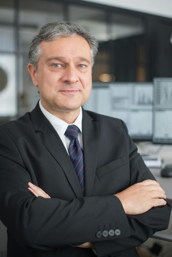 interim CEO in suit standing in modern office