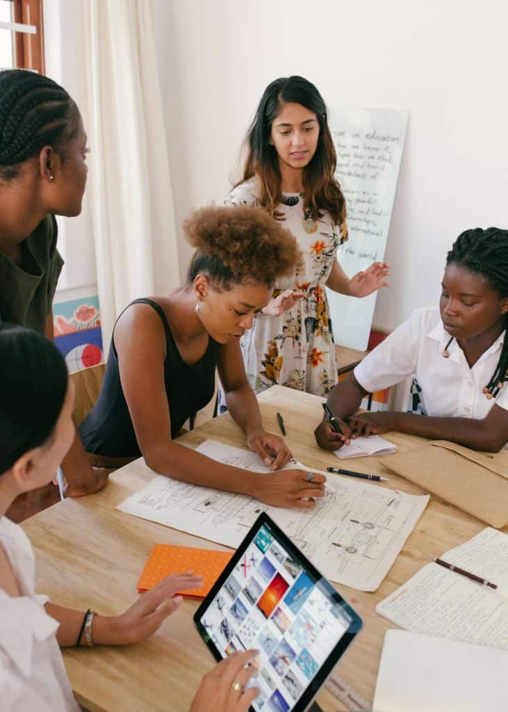 Team of business optimization professionals discuss plans